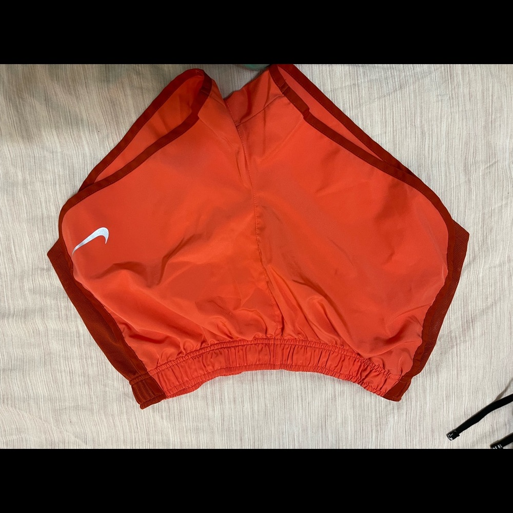 Orange and maroon nike running shorts